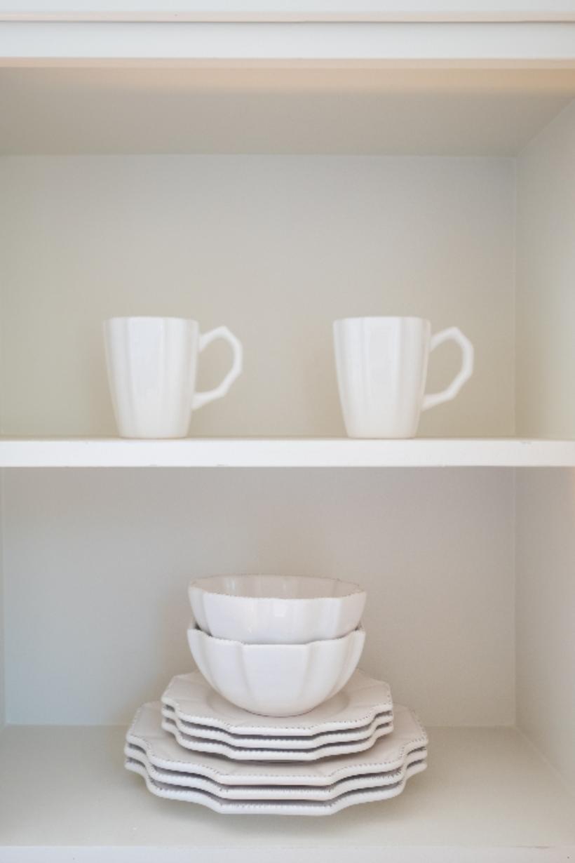 Freshly painted shelving with plain white dishes