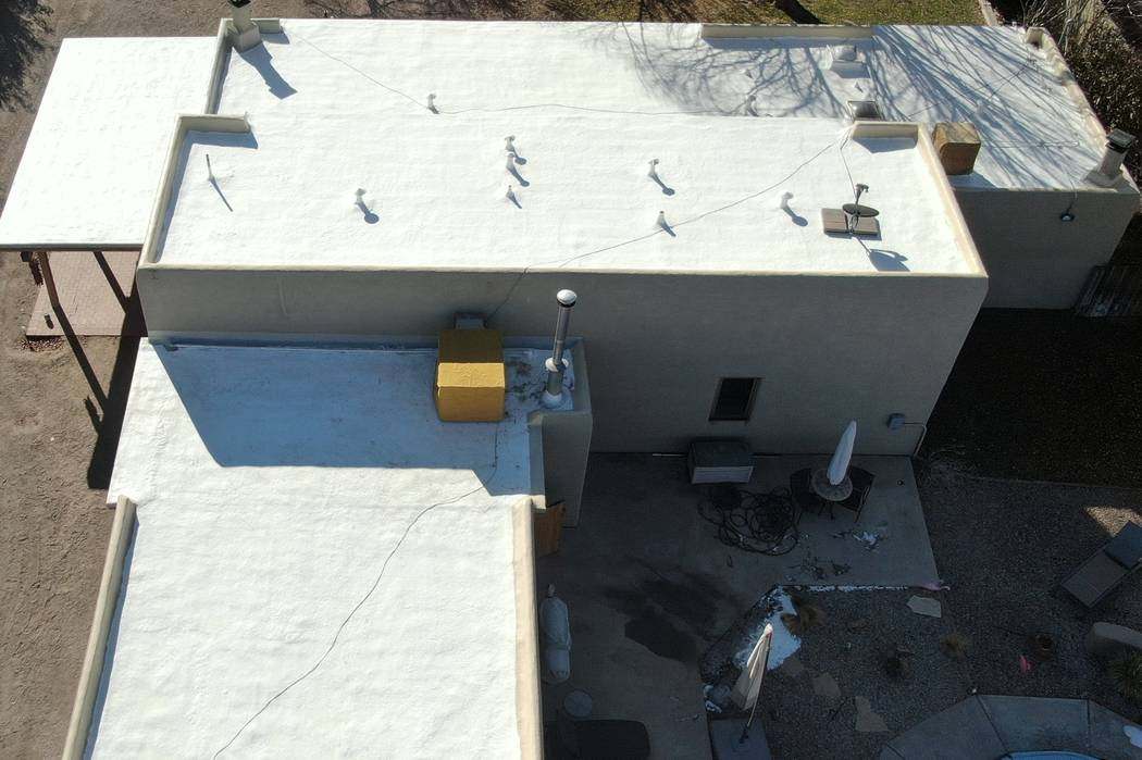 A flat desert roof after a bright white coating, seen from above