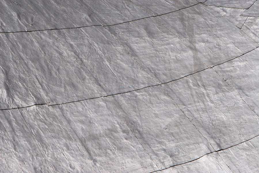 The surface of a coated roof membrane in raking light