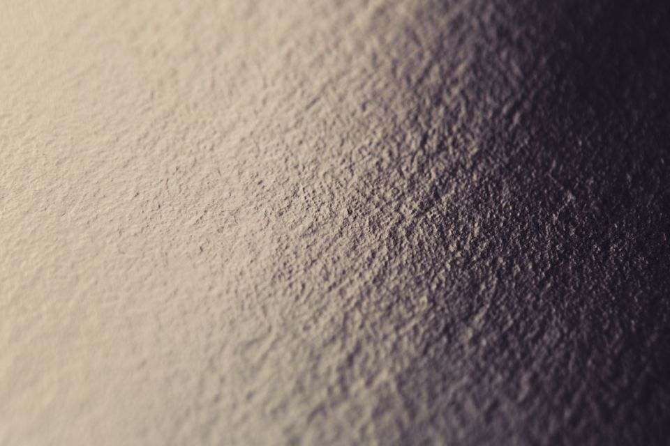 A freshly coated stucco wall in low sun